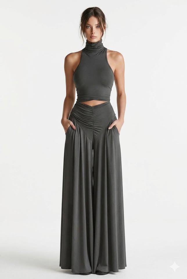 Slim-fit two-piece knit ensemble in dark gray, featuring a sleeveless turtleneck top and wide-leg A-line pants with pockets.