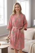 Blonde model wearing the pink gauze robe